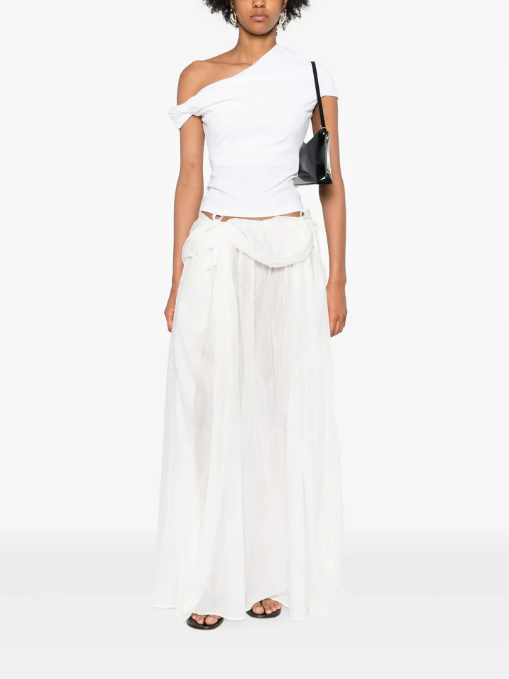 Paris Georgia silk-voile pleated skirt in white styled with an asymmetrical top and black shoulder bag