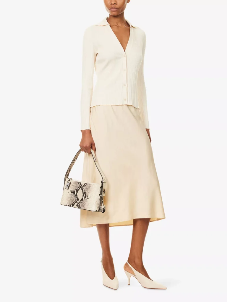 VINCE pull-on satin midi slip skirt in chamomile styled with a ribbed knit top and snake print shoulder bag